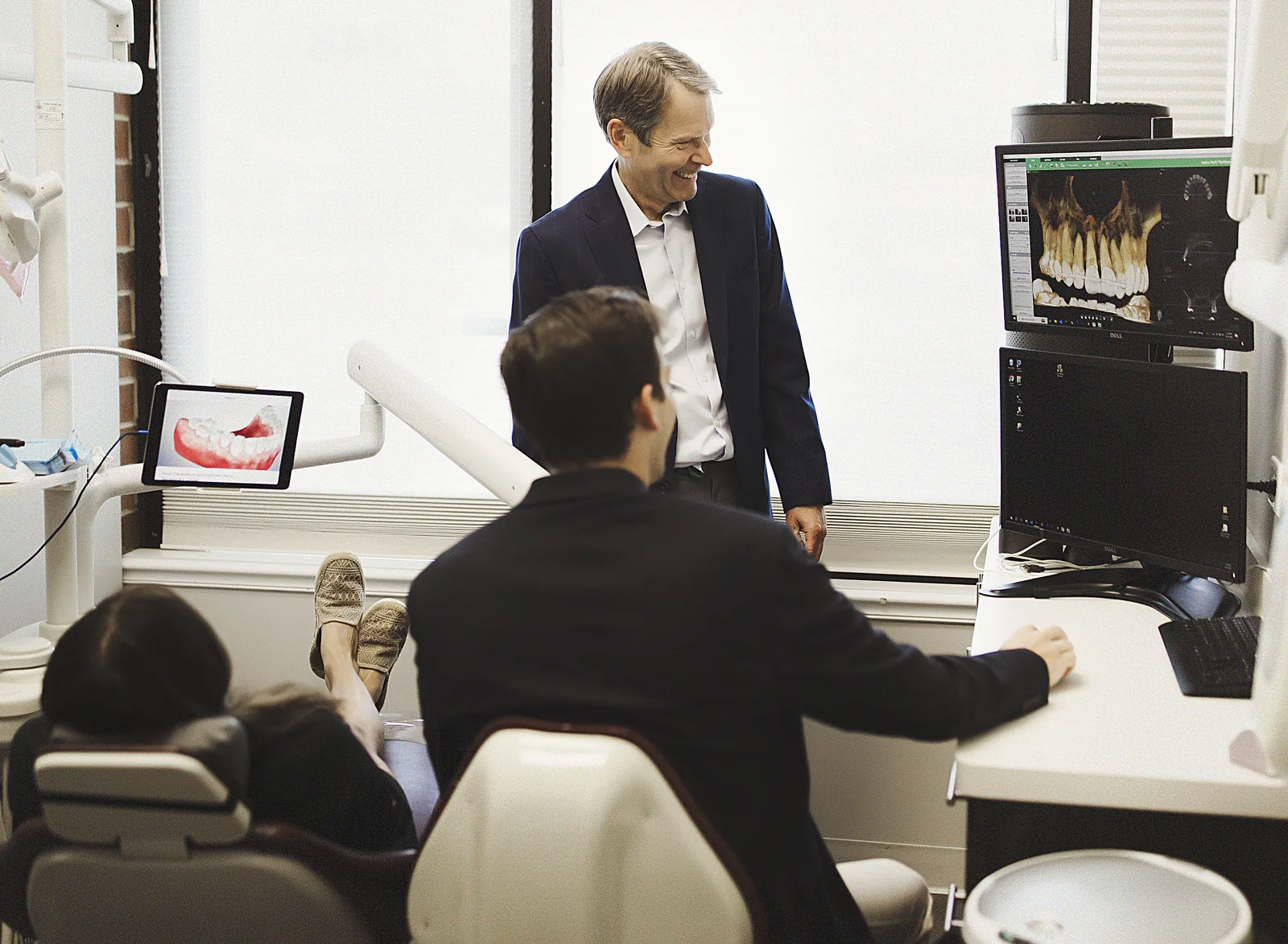 Dr. Anthony and Dr. David Markiewicz reviewing a patient's 3D scan and CBCT imaging chairside