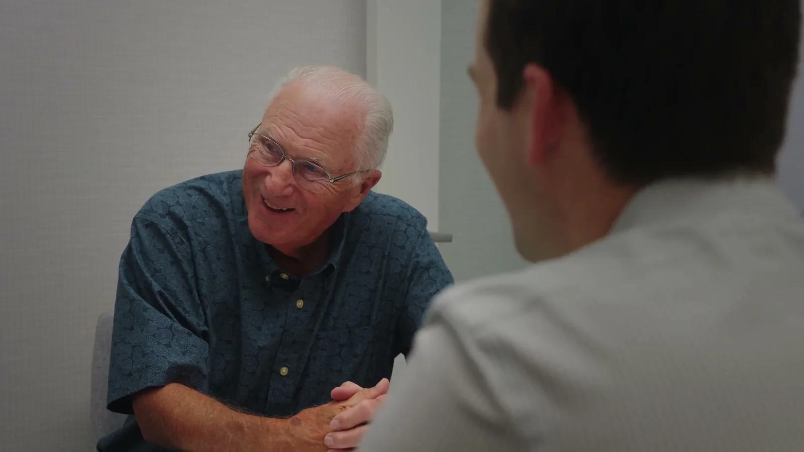 Dr. David Markiewicz sitting and talking with a longtime patient in the Markiewicz Dental office