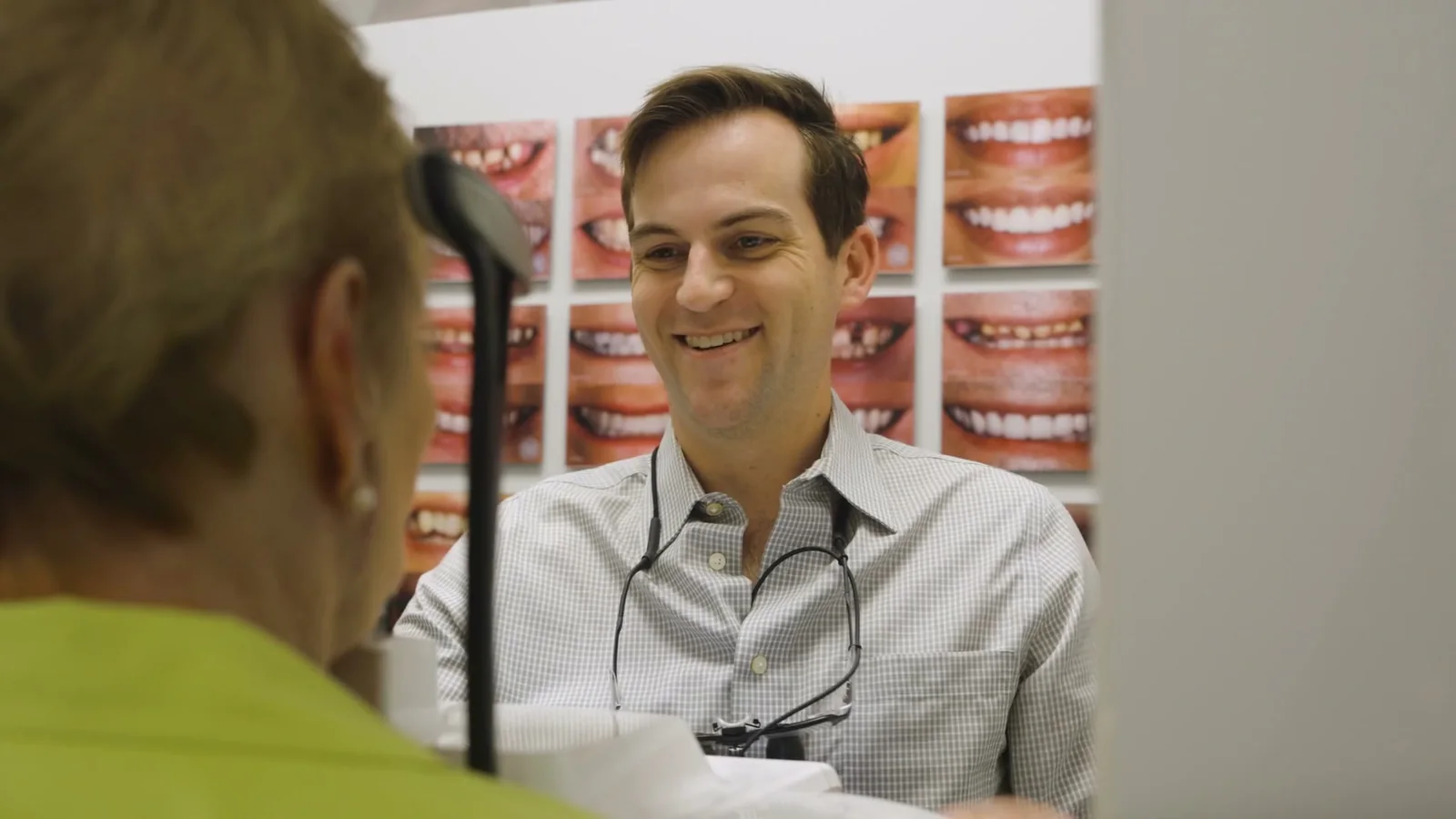 Dr. David Markiewicz smiling while talking with a patient in the treatment room